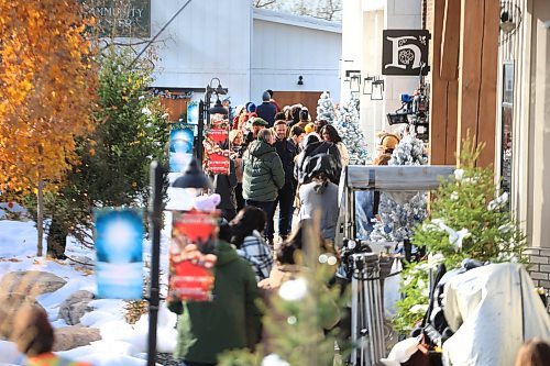 Ruth Bonneville / Free Press

Standup -Hallmark Christmas movie

Hallmark film crews create a Christmas scene by spraying white foam on the grounds  to resemble snow in the Village at Pine Ridge Hollow Monday.  

The scene was a flurry of activity with actors, film crews and a large group of extras all dressed in coats and scarfs acting as shoppers in the Christmas market.  

The television movie starting fill-in in early October and is currently entitled &quot;Following Yonder Star&quot;.

 
Oct 21st , 2023
