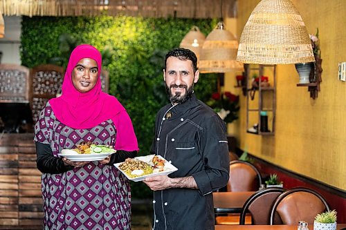 MIKAELA MACKENZIE / FREE PRESS
	
Sucad Mahamad with the lamb shank and rice (left) and Amer Alzubi with the chicken shawarma plate at Som Legacy Restaurant on Tuesday, Oct. 15, 2024.

For Eva story.
Winnipeg Free Press 2024