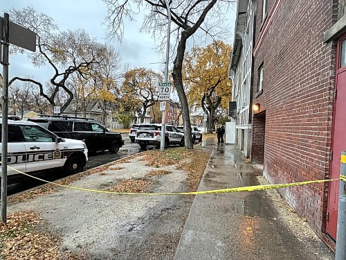 Police outside a building on Sherbrook Street just north of Ellice Avenue after a man with a gun was seen Tuesday morning. (Ruth Bonneville / Free Press)
