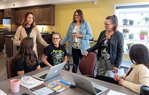 Agassiz's Progressive Conservative MLA Jodie Byram, (standing, second from right) meets with staff of OTTER Centre in Carberry. From left, Kayla Sampson (sitting), co-founder Tessa McPhee (standing), Natasha Leslie (sitting), co-founder Catherine Arnold (standing) and Sarah Friesen (sitting). Otter stands for overcoming trauma through everlasting relationships and is a 16-bed facility set up to reunite and support mothers and families who have been caught up or entangled in the child and family service system. (Michele McDougall/The Brandon Sun)