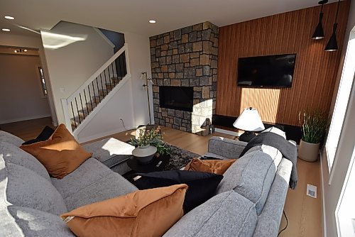 Todd Lewys / Free Press
Warmth radiates from the great room thanks to a gas fireplace with stone surround and beautiful wood-slat feature wall behind the TV.