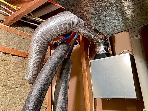 Marc LaBossiere / Free Press
The exhaust fan housing protrudes along the unfinished wall of the utility room allowing easy venting to the exterior through an abandoned window opening.