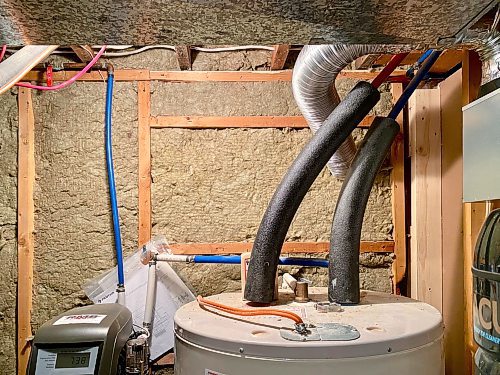 Marc LaBossiere / Free Press
The small inward-opening window behind the hot-water tank was permanently removed to eliminate moisture and dust breach, allowing an easy path for the ducting to vent the new exhaust fan to the exterior.