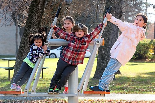 Siblings Trinity, Lexi, Tristan and Scarlett Desmarais play together on the exercise equipment at Stanley Park on a mild Thursday. (Tim Smith/The Brandon Sun)