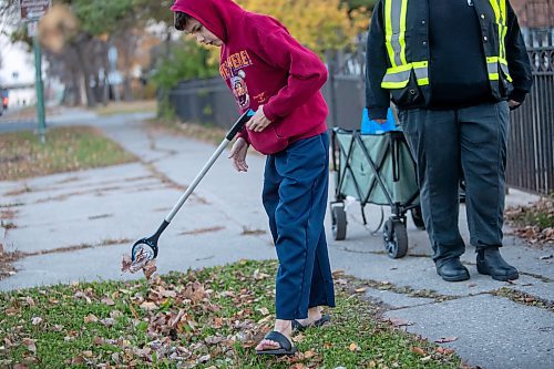 BROOK JONES/FREE PRESS
Sabu's Cubs volunteer Jaiger picks up garbage as he participates in the group's weekly community walk in North Point Douglas in Winnipeg, Man., Wednesday, Oct. 23, 2024.