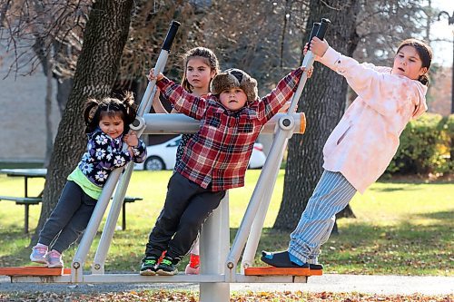 24102024
Siblings Trinity, Lexi, Tristan and Scarlett Desmarais play together on the exercise equipment at Stanley Park on a mild Thursday. 
(Tim Smith/The Brandon Sun)