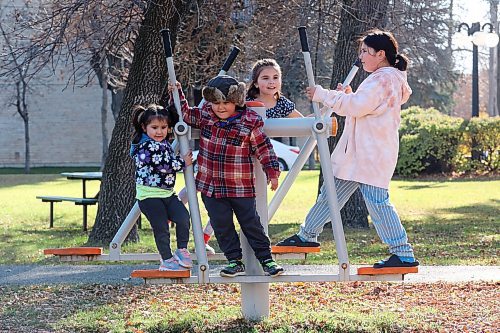 24102024
Siblings Trinity, Tristan, Lexi and Scarlett Desmarais play together on the exercise equipment at Stanley Park on a mild Thursday. 
(Tim Smith/The Brandon Sun)