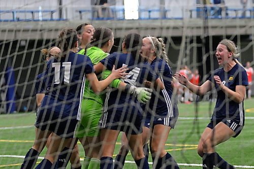 The Bobcats mob goalkeeper Josie Black after she saved a penalty kick to secure the MCAC women's soccer title. (Thomas Friesen/The Brandon Sun)