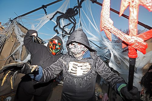 Carla and Mike Mitchell prepare to scare and entertain visitors to their Cedar Hollow haunted house on Cedar Bay in Brandon on Friday evening. The haunted house runs tonight and Halloween from 5-9 p.m. with a milder scare-free haunted house Sunday from 2-6 p.m. Non-perishable goods and other items are being collected for Samaritan House Ministries. This is the second year the Mitchells have operated the haunted house on Cedar Bay, with help from family and friends. See more photos on Page A5. (Tim Smith/The Brandon Sun)