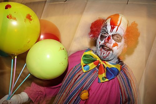 25102024
Creepy clown Bryan Mitchell gets ready to give visitors a fright at Cedar Hollow haunted house on Cedar Bay in Brandon on Friday evening. The haunted house runs Friday, Saturday and Halloween from 5-9PM and with a milder scare-free haunted house Sunday from 2-6PM. Non-perishable goods and other items are being collected for Samaritan House Ministries. 
(Tim Smith/The Brandon Sun)