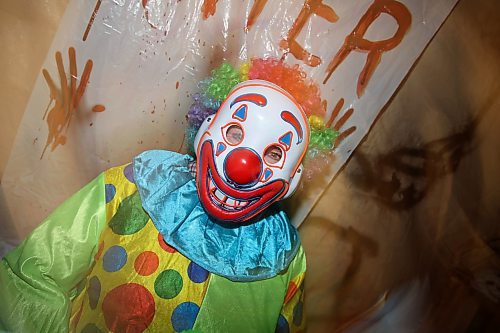 25102024
Creepy clown Donna Robleski gets ready to give visitors a fright at Cedar Hollow haunted house on Cedar Bay in Brandon on Friday evening. The haunted house runs Friday, Saturday and Halloween from 5-9PM and with a milder scare-free haunted house Sunday from 2-6PM. Non-perishable goods and other items are being collected for Samaritan House Ministries. 
(Tim Smith/The Brandon Sun)