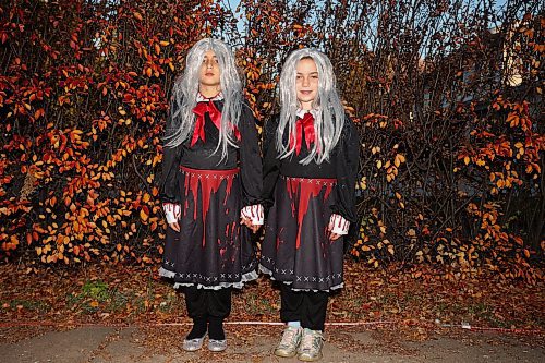 25102024
Eight-year-old twin sisters Emma and Claire Mitchell await those brave enough to enter Cedar Hollow haunted house on Cedar Bay in Brandon on Friday evening. The haunted house runs Friday, Saturday and Halloween from 5-9PM and with a milder scare-free haunted house Sunday from 2-6PM. Non-perishable goods and other items are being collected for Samaritan House Ministries. 
(Tim Smith/The Brandon Sun)