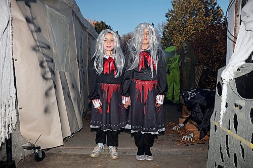 25102024
Eight-year-old twin sisters Claire and Emma Mitchell await those brave enough to enter Cedar Hollow haunted house on Cedar Bay in Brandon on Friday evening. The haunted house runs Friday, Saturday and Halloween from 5-9PM and with a milder scare-free haunted house Sunday from 2-6PM. Non-perishable goods and other items are being collected for Samaritan House Ministries. 
(Tim Smith/The Brandon Sun)