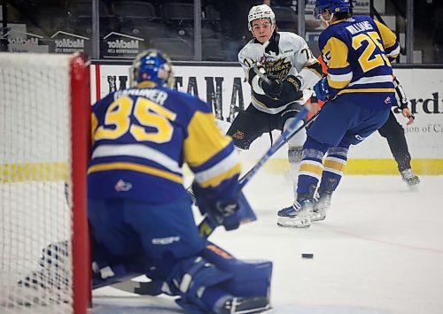 25102024
Brady Turko #71 of the Brandon Wheat Kings passes the puck out in front of netminder Evan Gardner #35 of the Saskatoon Blades during first period WHL action at Westoba Place on Friday evening.
(Tim Smith/The Brandon Sun)