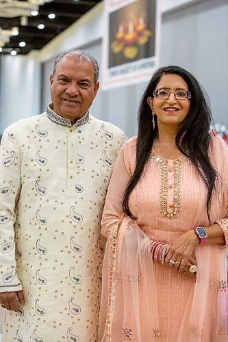 BROOK JONES/FREE PRESS
The Hindu Society of Manitoba hosts its annual Diwali Mela (Festival of Lights) at the RBC Convention Centre in Winnipeg, Man. Saturday, Oct. 19, 2024. Pictured: Jagmohan Wadhawan (left) is wearing a sherwani and Nitga Wadhawan is wearing a modern lehenga choli.