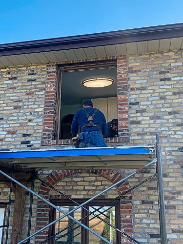 Marc LaBossiere / Free Press
To tackle the second-floor windows, scaffolding is positioned just below the window location to ease removal of the old and insertion of the new.