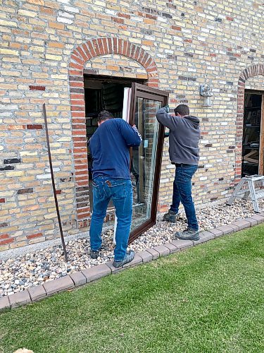 Marc LaBossiere / Free Press
The Overcode crew positions a new unit within the existing rough opening of sandstone brick.