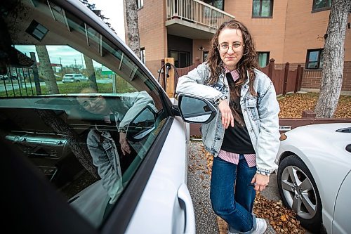 MIKAELA MACKENZIE / FREE PRESS
	
Michelle Panting and one of Peg City Car Co-op&#x2019;s two new electric fleet vehicles (and a new level 11 charging station) in Winnipeg on Tuesday, Oct. 29, 2024.

For Martin Cash story.
Winnipeg Free Press 2024