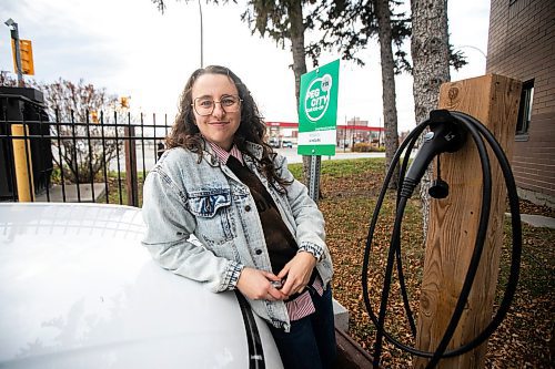 MIKAELA MACKENZIE / FREE PRESS
	
Michelle Panting and one of Peg City Car Co-op&#x2019;s two new electric fleet vehicles (and a new level 11 charging station) in Winnipeg on Tuesday, Oct. 29, 2024.

For Martin Cash story.
Winnipeg Free Press 2024