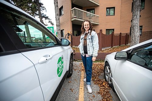 MIKAELA MACKENZIE / FREE PRESS
	
Michelle Panting and one of Peg City Car Co-op&#x2019;s two new electric fleet vehicles (and a new level 11 charging station) in Winnipeg on Tuesday, Oct. 29, 2024.

For Martin Cash story.
Winnipeg Free Press 2024