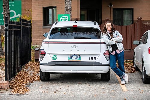 MIKAELA MACKENZIE / FREE PRESS
	
Michelle Panting and one of Peg City Car Co-op&#x2019;s two new electric fleet vehicles (and a new level 11 charging station) in Winnipeg on Tuesday, Oct. 29, 2024.

For Martin Cash story.
Winnipeg Free Press 2024