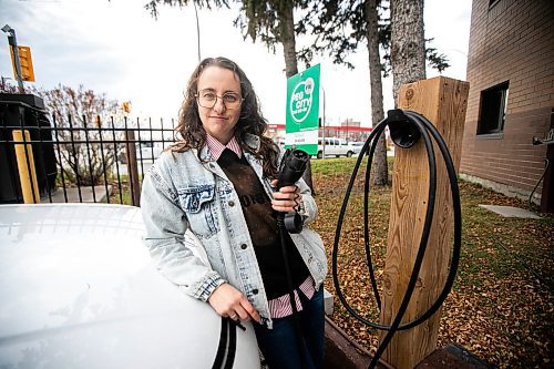 MIKAELA MACKENZIE / FREE PRESS
	
Michelle Panting and one of Peg City Car Co-op&#x2019;s two new electric fleet vehicles (and a new level 11 charging station) in Winnipeg on Tuesday, Oct. 29, 2024.

For Martin Cash story.
Winnipeg Free Press 2024