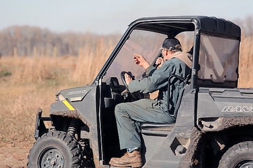 Curtis Gerow points out at the field where cattle will soon be herded. He rides with Quintinn Arndt, a 15-year-old learning to be a beef producer in his first year of the 4H beef program. (Connor McDowell/Brandon Sun)