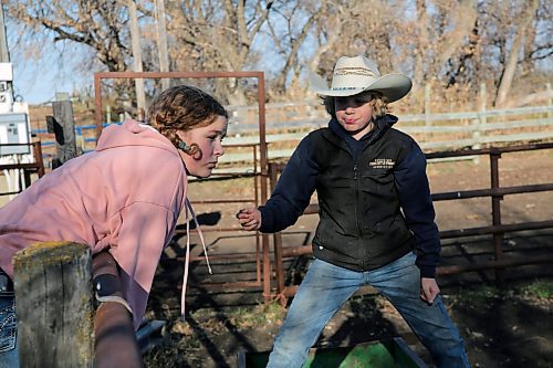 Evelyn and Elliott Burns are hanging out by the fence, picking which calf they want to raise this year for the 4H beef program. The program will have them learn how to take care of a cow and present it for a show next July. Together they have five years combined experience. (Connor McDowell/Brandon Sun)