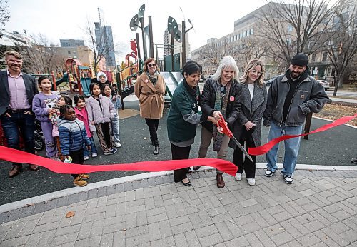 JOHN WOODS / FREE PRESS
Children watch and play on a play structure as politicians and stakeholders, from left, Linda Xie, Mosaic Newcomer Family Resource Network, Val Carvers, Executive Director, Mosaic Newcomer Family Resource Network, Heather Olson, Executive Director, Knox Day Nursery, and artist Bistyek hold an opening ceremony of the renovated play structure in Central Park Tuesday October 29, 2024.

Reporter: s/u