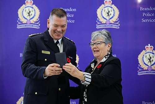 Brandon Police Board Chair Deb Arpin presents new Brandon Police Service Chief Tyler Bates with his badge and his certificate of appointment during his swearing-in ceremony at the Brandon Armoury on Wednesday.
(Tim Smith/The Brandon Sun)