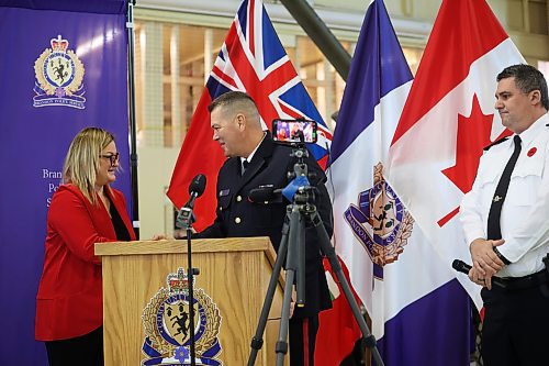 30102024
Judge Shauna Hewitt-Michta congratulates new Brandon Police Service Chief Tyler Bates after he took his oath of office and oath of allegiance during his swearing in ceremony at the Brandon Armoury on Wednesday.
(Tim Smith/The Brandon Sun)