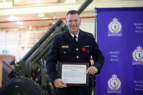 30102024
Newly sworn in Brandon Police Service Chief Tyler Bates receives his certificate of appointment during his swearing in ceremony at the Brandon Armoury on Wednesday.
(Tim Smith/The Brandon Sun)