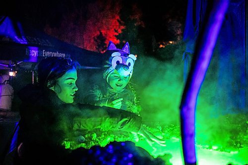 MIKAELA MACKENZIE / FREE PRESS
	
Jaiden (left) and four-year-old Alaia Lane check out at a steamy cauldron at Boo at the Zoo on Wednesday, Oct. 30, 2024.

Standup.
Winnipeg Free Press 2024