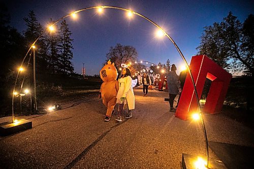 MIKAELA MACKENZIE / FREE PRESS
	
Airana Sumner (left, nine) and Sarah Koszas (nine) walk through lit arches at Boo at the Zoo on Wednesday, Oct. 30, 2024.

Standup.
Winnipeg Free Press 2024