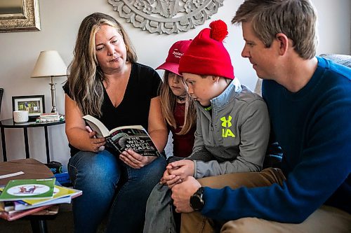 MIKAELA MACKENZIE / FREE PRESS
	
Carrie (left), Joey (seven), Emmett (11), and Alden Wood read books in their living room on Wednesday, Oct. 30, 2024.

For Maggie story.
Winnipeg Free Press 2024