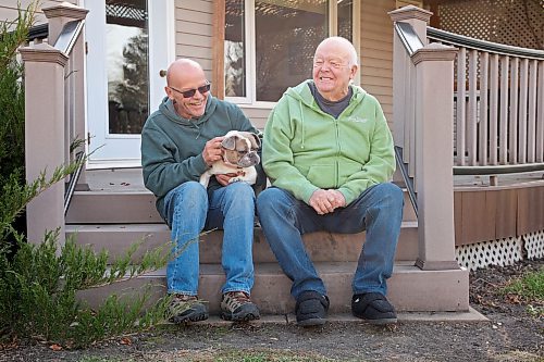 Lawrence Medd and his father Bill Medd sit with Lawrence’s french bulldog Lola at the home they are currently staying at in Killarney. Lawrence is visiting his dad in Killarney from Alberta. Lola woke them in the night on Oct. while Bill’s duplex went up in flames. The duplex on Finlay Street was completely destroyed in the fire, but the Medds and the duplex’s other resident all escaped the blaze. 
(Tim Smith/The Brandon Sun)