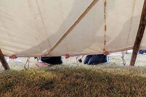 MIKE DEAL / FREE PRESS
Maples Collegiate students hammer in pegs to hold down the canvas of the tipi.
Indigenous youth from Maples Collegiate learn to put up and take down a tipi Thursday morning at Ozhaawashkwaa Animikii-Bineshi Aki Onji Kinimaagae&#x2019; Inun, Seven Oaks School Division&#x2019;s land-based learning centre.
There&#x2019;s ever-growing demand for land-based learning and recognition of their important place across the province's public school system. Teachers have increasingly sought elders&#x2019; expertise and planned field trips to sites such as Ozhaawashkwaa Animikii-Bineshi Aki Onji Kinimaagae&#x2019; Inun (Blue Thunderbird Land-based Teachings Learning Centre), also known as the Aki Centre. The Aki Centre spans 50 acres, much of which is undergoing restoration so the over-farmed grounds return to their original state as a tallgrass prairie and wetland, in West St. Paul. The Seven Oaks School Division has facilitated rabbit snaring, moose and deer hyde tanning, and the harvesting of sage, sweetgrass and tobacco, since opening it in 2019. More than 5,000 visitors stopped by the Grassmere Road site that houses vegetable and medicine gardens, a sweat lodge and a greenhouse in 2023-24. In doing so, they learned about ecosystems, treaties, conservation and other related topics.
Reporter: Maggie Macintosh
241031 - Thursday, October 31, 2024.