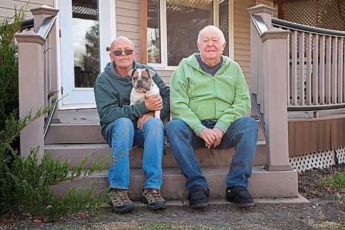 31102024
Lawrence Medd and his father Bill Medd sit with Lawrence&#x2019;s french bulldog Lola at the home they are currently staying at in Killarney. Lawrence is visiting his dad in Killarney from Alberta. Lola woke them in the night Sunday as Bill&#x2019;s duplex went up in flames. The duplex on Finlay Street was completely destroyed in the fire but the Medd&#x2019;s and the duplex&#x2019;s other resident all escaped the blaze. 
(Tim Smith/The Brandon Sun)