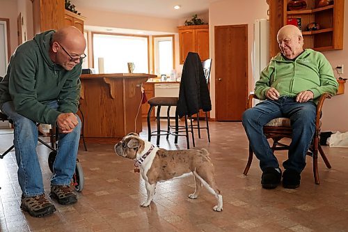 31102024
Lawrence Medd and his father Bill Medd sit with Lawrence&#x2019;s french bulldog Lola at the home they are currently staying at in Killarney. Lawrence is visiting his dad in Killarney from Alberta. Lola woke them in the night Sunday as Bill&#x2019;s duplex went up in flames. The duplex on Finlay Street was completely destroyed in the fire but the Medd&#x2019;s and the duplex&#x2019;s other resident all escaped the blaze. 
(Tim Smith/The Brandon Sun)