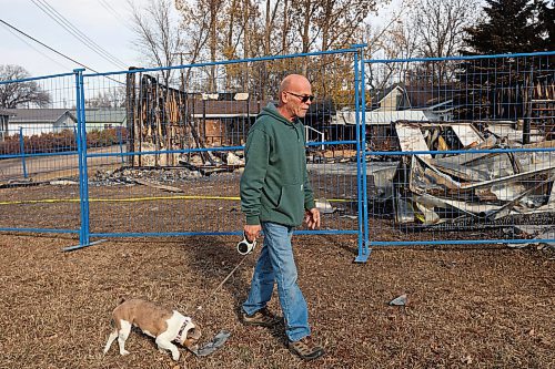 31102024
Lawrence Medd and his french bulldog Lola walk past the duplex his father Bill Medd lived in on Thursday. Lawrence is visiting his dad in Killarney from Alberta. Lola woke them in the night Sunday as Bill&#x2019;s duplex went up in flames. The duplex on Finlay Street was completely destroyed in the fire but the Medd&#x2019;s and the duplex&#x2019;s other resident all escaped the blaze. 
(Tim Smith/The Brandon Sun)