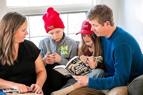 MIKAELA MACKENZIE / FREE PRESS
	
Carrie (left), Emmett (11), Joey (seven), and Alden Wood read books in their living room on Wednesday, Oct. 30, 2024.

For Maggie story.
Winnipeg Free Press 2024