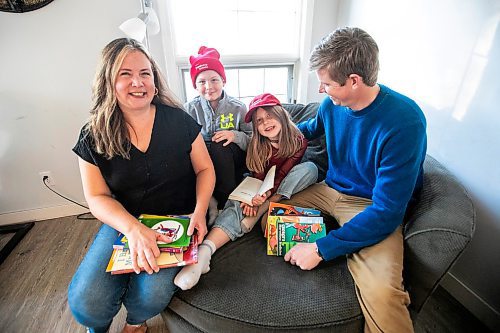 MIKAELA MACKENZIE / FREE PRESS
	
Carrie (left), Emmett (11), Joey (seven), and Alden Wood read books in their living room on Wednesday, Oct. 30, 2024.

For Maggie story.
Winnipeg Free Press 2024