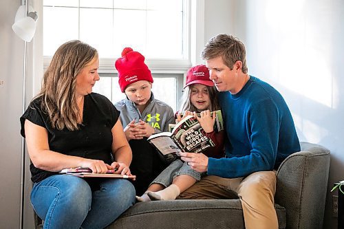 MIKAELA MACKENZIE / FREE PRESS
	
Carrie (left), Emmett (11), Joey (seven), and Alden Wood read books in their living room on Wednesday, Oct. 30, 2024.

For Maggie story.
Winnipeg Free Press 2024