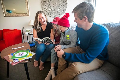 MIKAELA MACKENZIE / FREE PRESS
	
Carrie (left), Joey (seven), Emmett (11), and Alden Wood read books in their living room on Wednesday, Oct. 30, 2024.

For Maggie story.
Winnipeg Free Press 2024