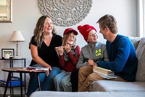 MIKAELA MACKENZIE / FREE PRESS
	
Carrie (left), Joey (seven), Emmett (11), and Alden Wood read books in their living room on Wednesday, Oct. 30, 2024.

For Maggie story.
Winnipeg Free Press 2024