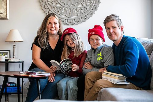 MIKAELA MACKENZIE / FREE PRESS
	
Carrie (left), Joey (seven), Emmett (11), and Alden Wood read books in their living room on Wednesday, Oct. 30, 2024.

For Maggie story.
Winnipeg Free Press 2024