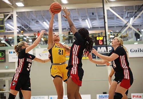 Amaya McLeod shoots over a pair of Wesmen defenders during the Bobcats' 71-68 loss. (Tim Smith/The Brandon Sun)