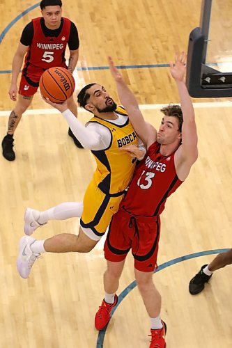 Brandon's Sultan Bhatti drives for a layup as Winnipeg's Donald Stewart contests during their Canada West men's basketball game at the Healthy Living Centre on Friday. (Thomas Friesen/The Brandon Sun)