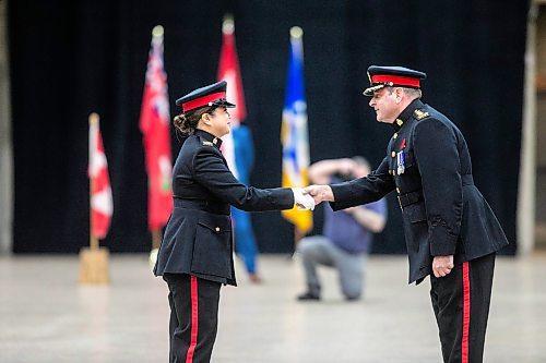 MIKAELA MACKENZIE / FREE PRESS
	
Graduate Chelsea Rebustillo shakes hands with acting police chief Gene Bowers during the graduation ceremony for the Winnipeg Police Service recruit class 170 at the RBC Convention Centre in Winnipeg on Friday, Nov. 1, 2024.

Standup.
Winnipeg Free Press 2024