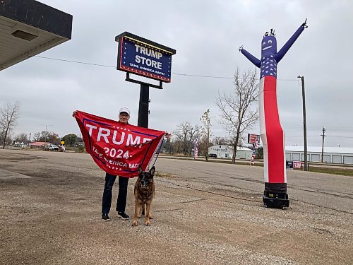 ADAM TREUSCH / FREE PRESS
Patrick Millard with a flag he bought at the Trump Store in Lake Park, Minn., on Saturday. 
